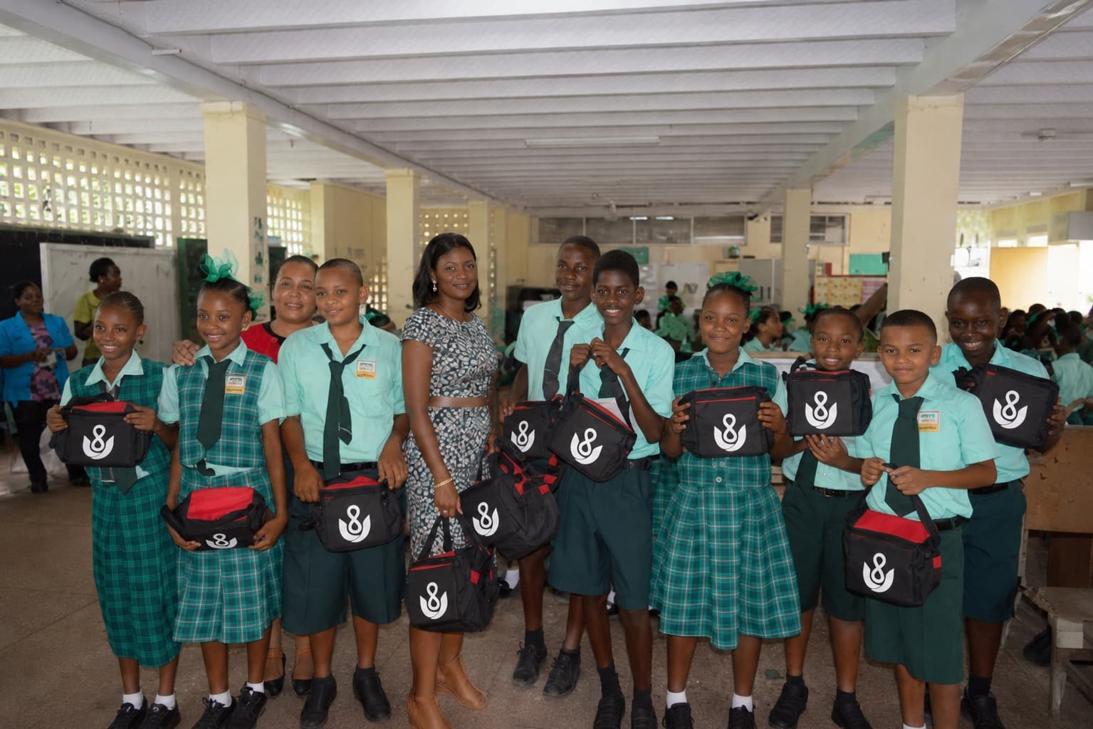 INFINYTUM donating branded supplies to students at an underprivileged school in Guyana